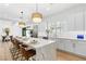 Bright kitchen with island, stainless steel appliances, pendant lights, and white cabinets at 5225 Villa Dante Ave, Las Vegas, NV 89141