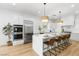 Modern kitchen featuring a large island, stainless steel appliances, and white cabinets at 5225 Villa Dante Ave, Las Vegas, NV 89141
