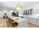 Modern kitchen with a large marble island, stainless steel appliances, and seamless dining area at 5225 Villa Dante Ave, Las Vegas, NV 89141