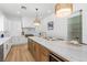 Kitchen island featuring white marble countertop, pendant lighting, and modern backsplash at 5225 Villa Dante Ave, Las Vegas, NV 89141
