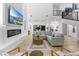 Open concept living room with fireplace, TV, modern sofas, and staircase at 5225 Villa Dante Ave, Las Vegas, NV 89141