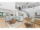 Spacious living room with white walls, hardwood floors, and a staircase at 5225 Villa Dante Ave, Las Vegas, NV 89141