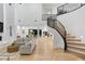 Open-concept living room featuring staircase and modern decor at 5225 Villa Dante Ave, Las Vegas, NV 89141