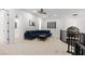 Upstairs loft with a blue sofa, ceiling fan, black railings, and views of multiple rooms at 5225 Villa Dante Ave, Las Vegas, NV 89141