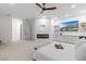Main bedroom suite with modern fireplace, ceiling fan, and built in TV console at 5225 Villa Dante Ave, Las Vegas, NV 89141
