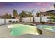 Swimming pool and hot tub with subtle lighting at dusk, surrounded by desert landscaping at 5225 Villa Dante Ave, Las Vegas, NV 89141