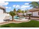 Backyard pool with a built-in jacuzzi and lush tropical landscaping at 5225 Villa Dante Ave, Las Vegas, NV 89141