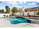 Swimming pool with a waterfall feature and attached hot tub, surrounded by desert landscaping at 5225 Villa Dante Ave, Las Vegas, NV 89141