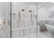 Large shower with marble-style tile, dual shower heads, and a built-in bench at 5225 Villa Dante Ave, Las Vegas, NV 89141