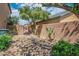 Rock landscaping, mature trees, and block wall in a private backyard at 53 Hoke Edward Ct, North Las Vegas, NV 89031