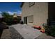Paver patio and rock landscaping with a sliding glass door and backyard toys at 53 Hoke Edward Ct, North Las Vegas, NV 89031