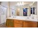 Bathroom featuring a double sink vanity and a large mirror and a view into a walk in closet at 53 Hoke Edward Ct, North Las Vegas, NV 89031