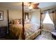 Spacious bedroom with a four-poster bed, ceiling fan, and bright window at 53 Hoke Edward Ct, North Las Vegas, NV 89031