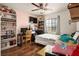 Lively bedroom featuring a ceiling fan, wooden floors, and built-in bookcase at 53 Hoke Edward Ct, North Las Vegas, NV 89031