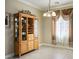 Dining room with a china cabinet, decorative window treatments, and neutral paint at 53 Hoke Edward Ct, North Las Vegas, NV 89031