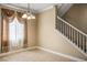 Clean dining room featuring natural light, white trim and neutral paint, leading to the stairway at 53 Hoke Edward Ct, North Las Vegas, NV 89031