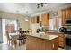 A spacious kitchen featuring an island, granite countertops, and stainless steel appliances at 53 Hoke Edward Ct, North Las Vegas, NV 89031