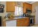 Well-lit kitchen featuring stainless steel appliances, granite countertops, and wood cabinetry at 53 Hoke Edward Ct, North Las Vegas, NV 89031