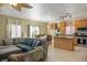 Open kitchen and living area with stainless appliances, an island, tile flooring, and plenty of natural light at 53 Hoke Edward Ct, North Las Vegas, NV 89031