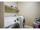Bright laundry room featuring a Samsung washer and dryer plus a storage shelf above at 53 Hoke Edward Ct, North Las Vegas, NV 89031