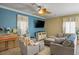 Comfortable living room with a ceiling fan, flat-screen TV, and stylish furniture on ceramic tile flooring at 53 Hoke Edward Ct, North Las Vegas, NV 89031
