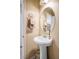 Updated powder room featuring a pedestal sink, large decorative mirror, and stylish finishes at 53 Hoke Edward Ct, North Las Vegas, NV 89031