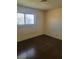 Bedroom with wood floors and a window overlooking the backyard at 5317 Holmby Ave, Las Vegas, NV 89146