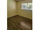 The bedroom has wood floors and a window at 5317 Holmby Ave, Las Vegas, NV 89146