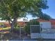 Exterior view of the front of the home with a large tree in the yard at 5317 Holmby Ave, Las Vegas, NV 89146