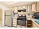 Traditional kitchen showcasing stainless steel appliances and patterned tile backsplash at 5317 Holmby Ave, Las Vegas, NV 89146