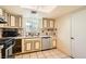 Traditional kitchen featuring a stainless steel dishwasher and a bright window at 5317 Holmby Ave, Las Vegas, NV 89146