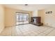 Spacious living room features tile floors, a brick fireplace, and sliding glass doors at 5317 Holmby Ave, Las Vegas, NV 89146
