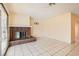 Bright living room with tile flooring and a brick fireplace, great for entertaining at 5317 Holmby Ave, Las Vegas, NV 89146