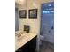 Bathroom featuring a vanity with a sink, a mirror with artwork above, and a shower/tub combination at 5466 Scotch Cap Dr, Las Vegas, NV 89122