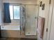 Bright bathroom featuring a soaking tub, glass-enclosed shower, and tile surround at 5466 Scotch Cap Dr, Las Vegas, NV 89122