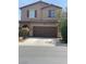 Charming two-story home features a well-manicured lawn, two-car garage and traditional architectural details at 5466 Scotch Cap Dr, Las Vegas, NV 89122