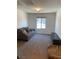 Cozy living room area with neutral carpet, a sofa, and a media console at 5466 Scotch Cap Dr, Las Vegas, NV 89122