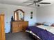 Bedroom featuring a ceiling fan, dresser with mirror, and a comfortable bed at 5466 Scotch Cap Dr, Las Vegas, NV 89122