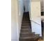 Carpeted staircase with white walls and railing leads to the upper level at 5466 Scotch Cap Dr, Las Vegas, NV 89122