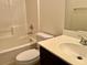 Bright bathroom featuring a shower over tub, neutral tile, a toilet, and vanity at 5653 Nobleton Ct, North Las Vegas, NV 89081