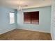 Bedroom featuring blue walls, chandelier, window, and neutral carpet at 5653 Nobleton Ct, North Las Vegas, NV 89081