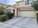 Charming two-story home featuring neutral paint, archway entry, 2-car garage, and manicured shrubbery at 5653 Nobleton Ct, North Las Vegas, NV 89081