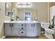 Updated bathroom featuring a double sink vanity, large mirror, and modern lighting fixtures at 5710 E Tropicana Ave # 2218, Las Vegas, NV 89122