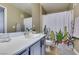 Bright bathroom featuring a vanity with a sink, modern fixtures, and a shower with a cheerful cactus-themed curtain at 5710 E Tropicana Ave # 2218, Las Vegas, NV 89122