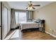 Comfortable bedroom with wood floors, natural light, closet, and a ceiling fan at 5710 E Tropicana Ave # 2218, Las Vegas, NV 89122