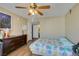 Inviting bedroom showcasing wood-look flooring, ceiling fan, and a large dresser for ample storage at 5710 E Tropicana Ave # 2218, Las Vegas, NV 89122