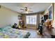 Inviting bedroom featuring a ceiling fan, wood floors, and a sunny window at 5710 E Tropicana Ave # 2218, Las Vegas, NV 89122