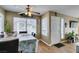Inviting dining area featuring wood floors, ceiling fan, and ample natural light from large windows at 5710 E Tropicana Ave # 2218, Las Vegas, NV 89122