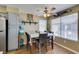 Cozy dining area featuring wood floors, seating for four, and a modern ceiling fan at 5710 E Tropicana Ave # 2218, Las Vegas, NV 89122