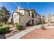 An exterior view showing well-manicured landscaping with condo's stucco and walkways at 5710 E Tropicana Ave # 2218, Las Vegas, NV 89122